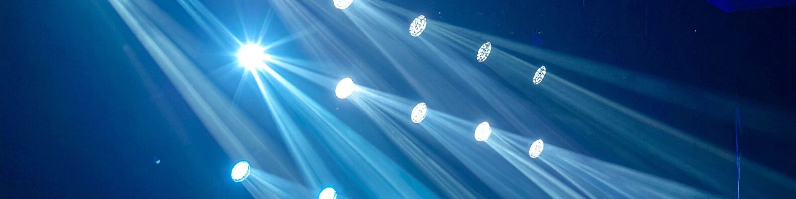 Stage lighting beams showing different lighting moods in a performance venue